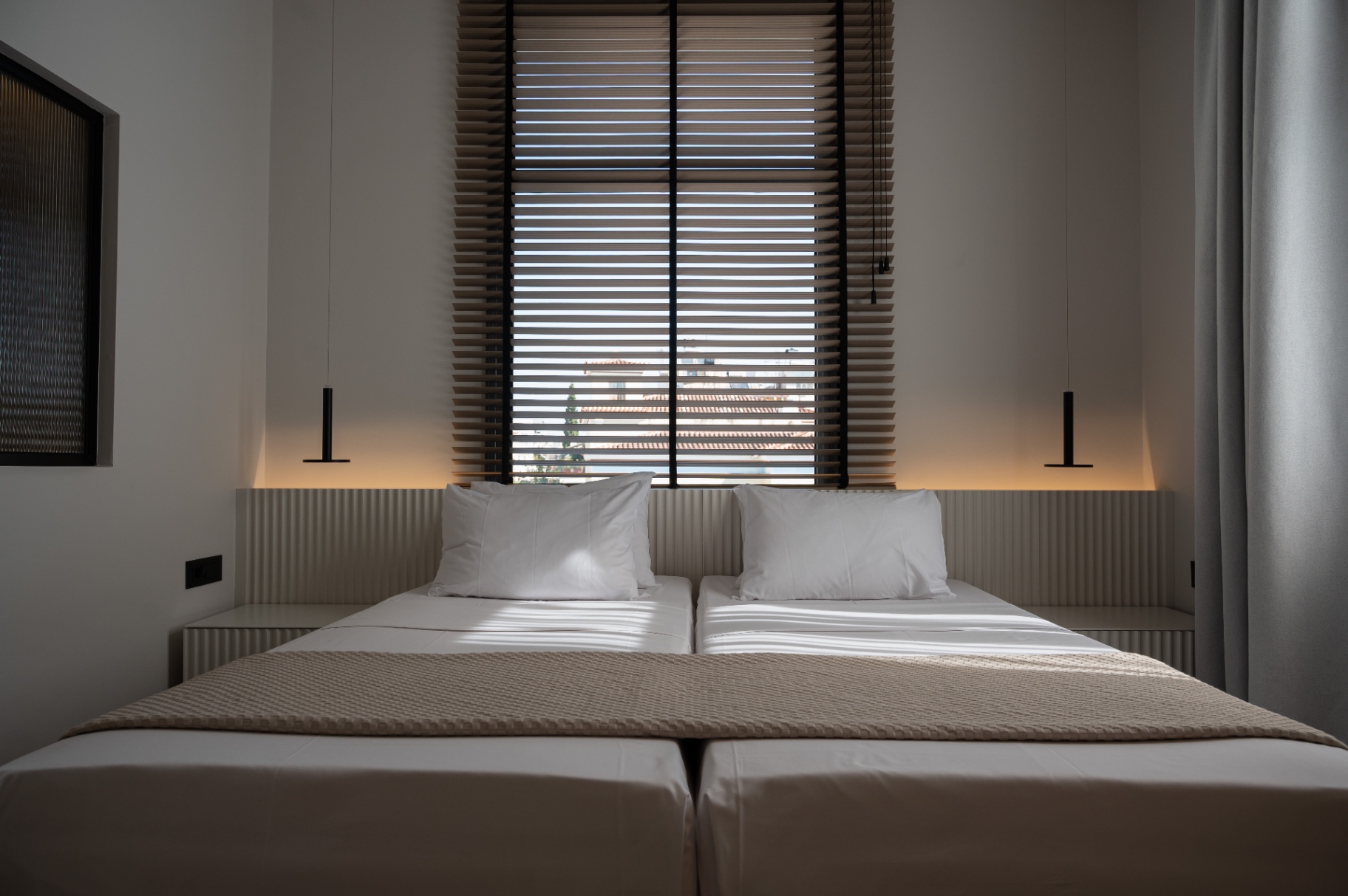 Deluxe Room with Extra Bed — headboard detail with pendant lighting