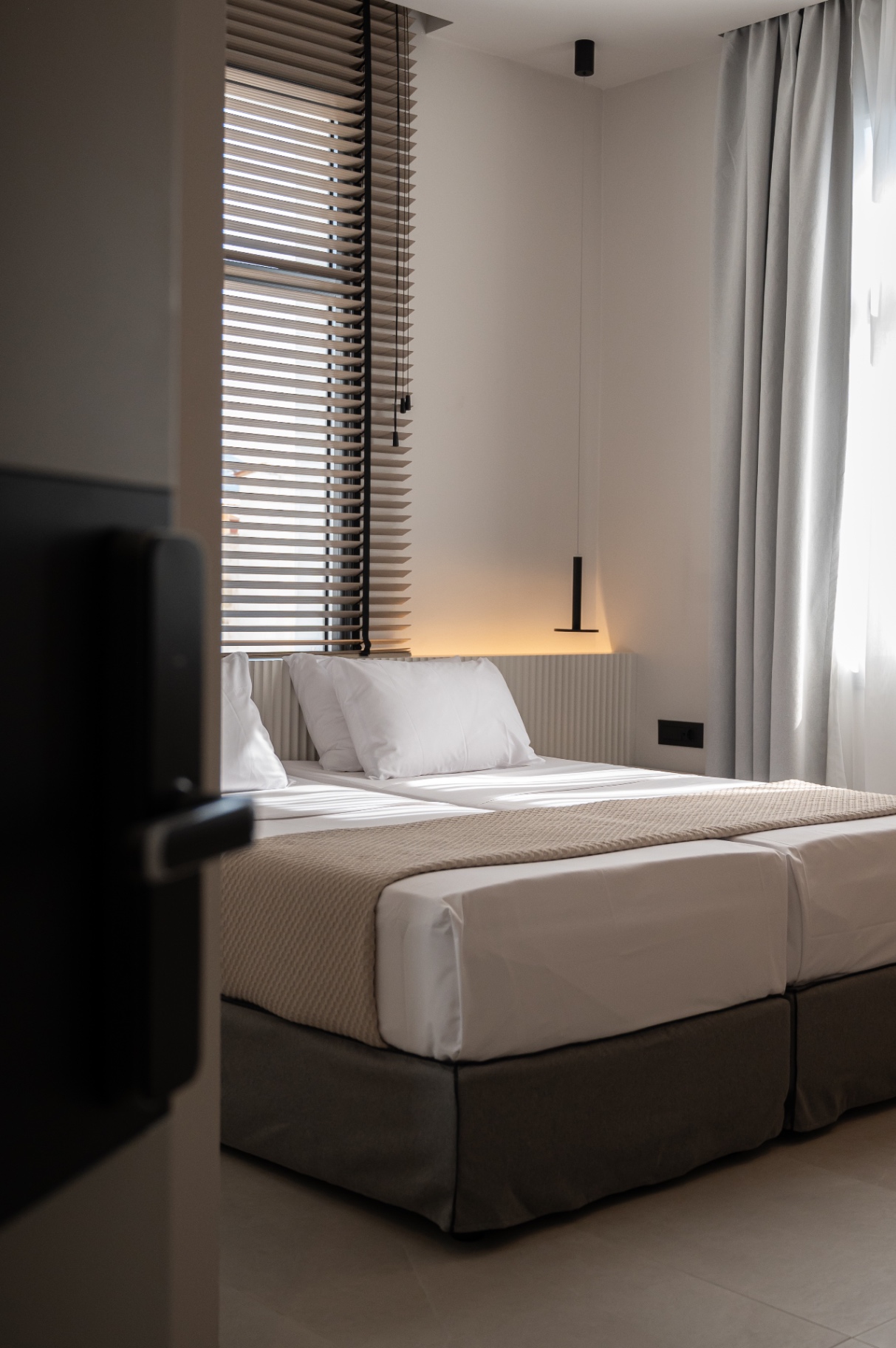 Deluxe Room with Extra Bed — bed detail with soft morning light