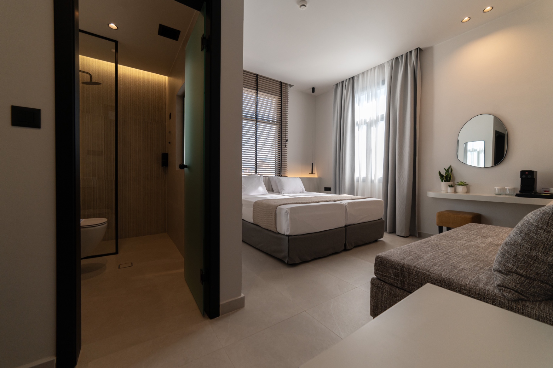 Deluxe Room with Extra Bed — open layout with sofa bed corner