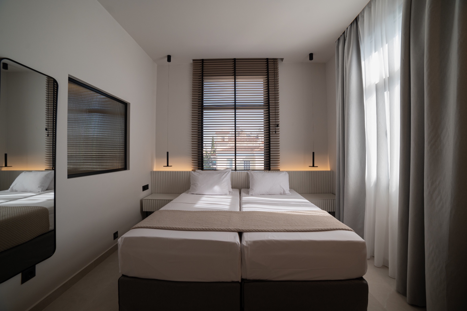 Deluxe Room with Extra Bed — twin beds and natural light