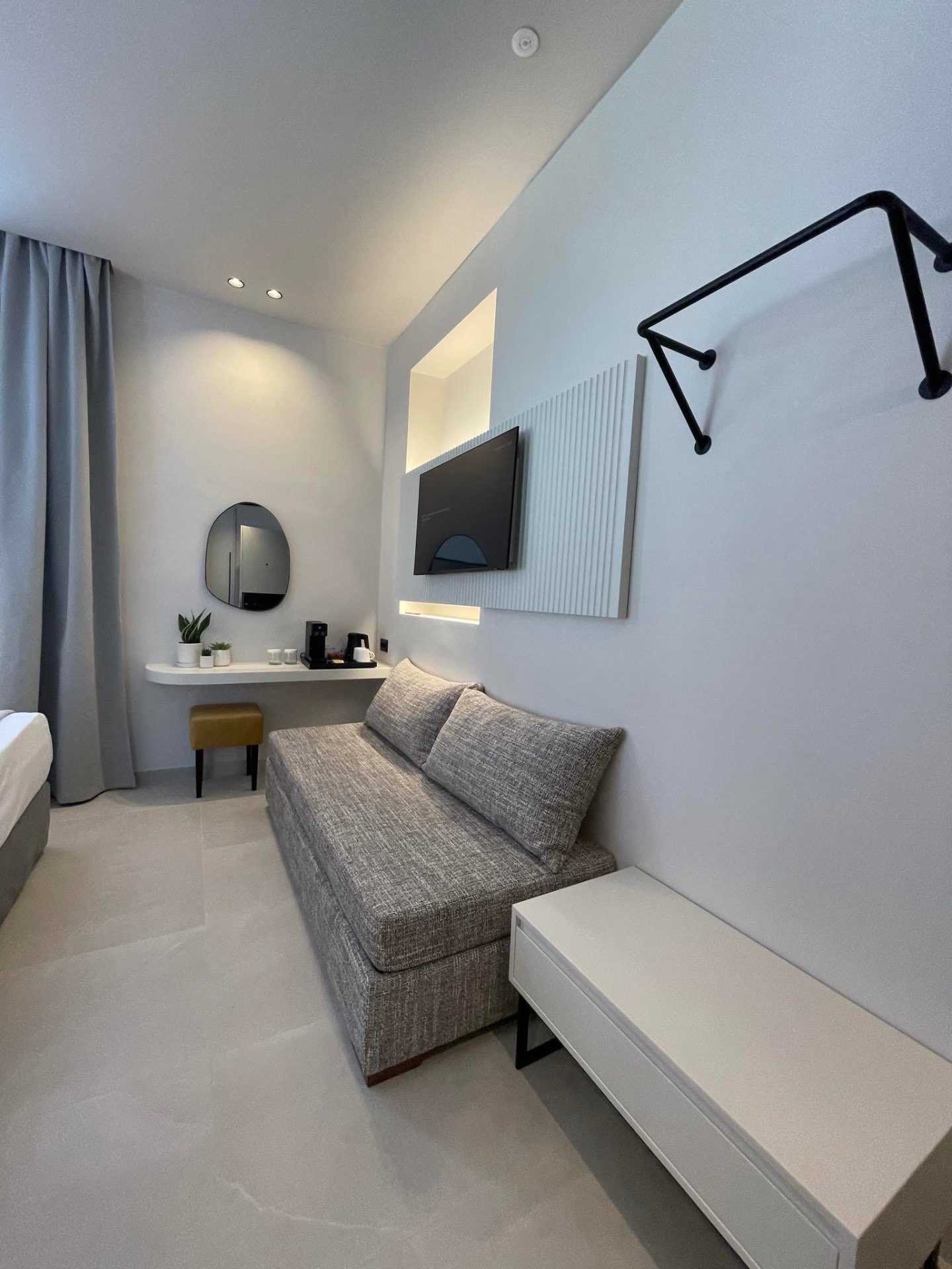 Deluxe Room with Extra Bed — spacious sofa bed lounge with smart TV